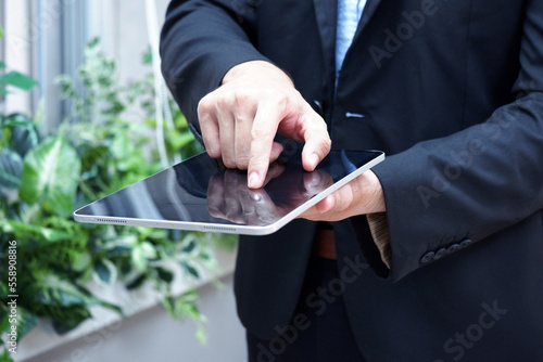 hand touching tablet businessman in suit.