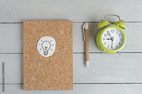 alarm clock, notepad for writing, pen. Planing koncept. Yop view. Biznes koncept