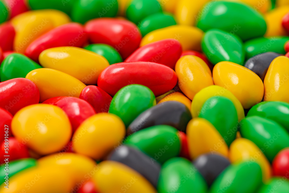 Candy in multi colored glaze in bulk, close-up macro, mini pieces, wallpaper background, selective focus Candy in multi colored glaze in bulk, close-up macro, mini pieces, wallpaper background, selective focus