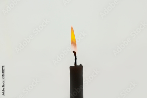 burning candle on a white background