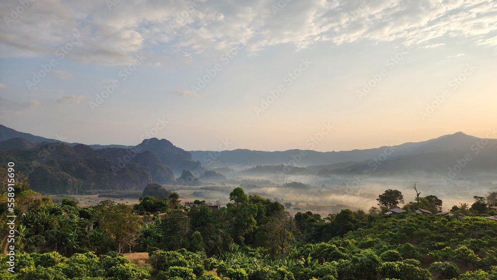 Fototapeta premium Beautiful bird's-eye view of the sea of mist in the green mountain forest, Phu Chee Fah, Thoeng District, Chiang Rai, Thailand.