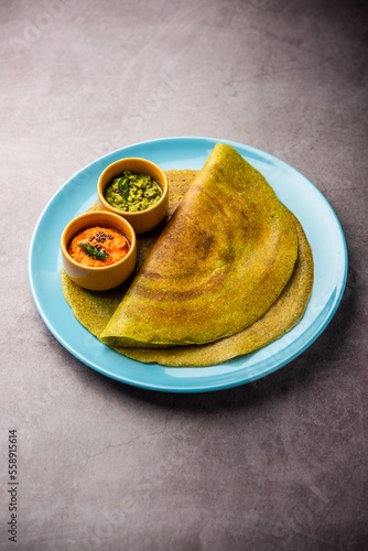 Pesarattu Dosa or moong dosai is Indian breakfast crepes with green gram served with chutney photo