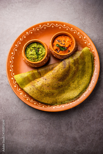 Pesarattu Dosa or moong dosai is Indian breakfast crepes with green gram served with chutney photo