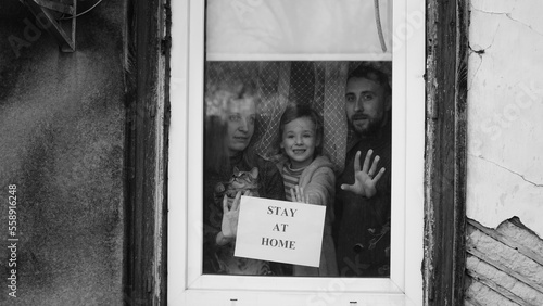 Lettering Stay Home Safe Campaign. A happy european family remained at quarantine self-isolation. Pandemic coronavirus covid 19 responsibility conscious decision. message poster preventive measures