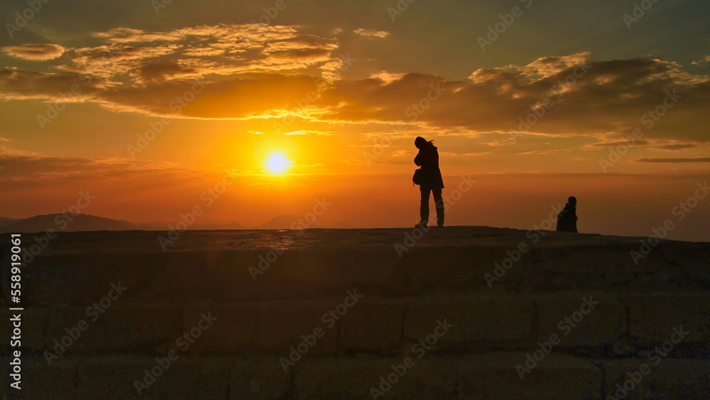 silhouette of a person walking on the terrace
