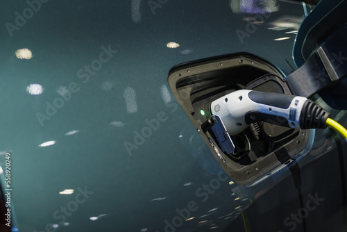 The power supply connects to electric vehicles to charge batteries, charging industrial transport technology, which is the future of EV vehicles. Fuel is plugged into a hybrid vehicle. at the launch e