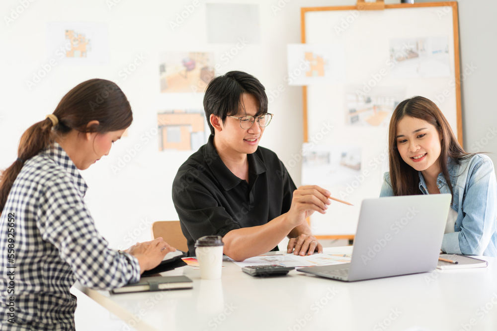 Construction design concept, Architects team is look house plan on laptop to discussing together Construction design concept, Architects team is look house plan on laptop to discussing together
