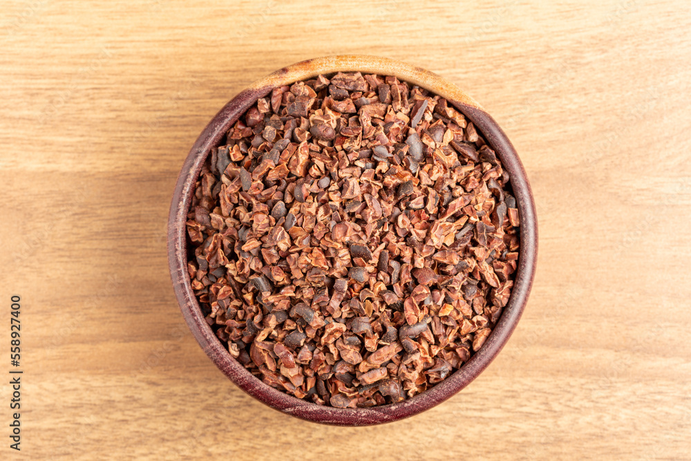Bowl with cocoa nibs on the table. Bowl with cocoa nibs on the table.