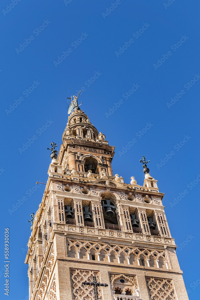 Roman Catholic Cathedral of Saint Mary of the See (Catedral de Santa Maria de la Sede, 1528). Giralda (La Giralda) - 104.1 m bell tower of Seville Cathedral. Seville, Andalusia, Spain.