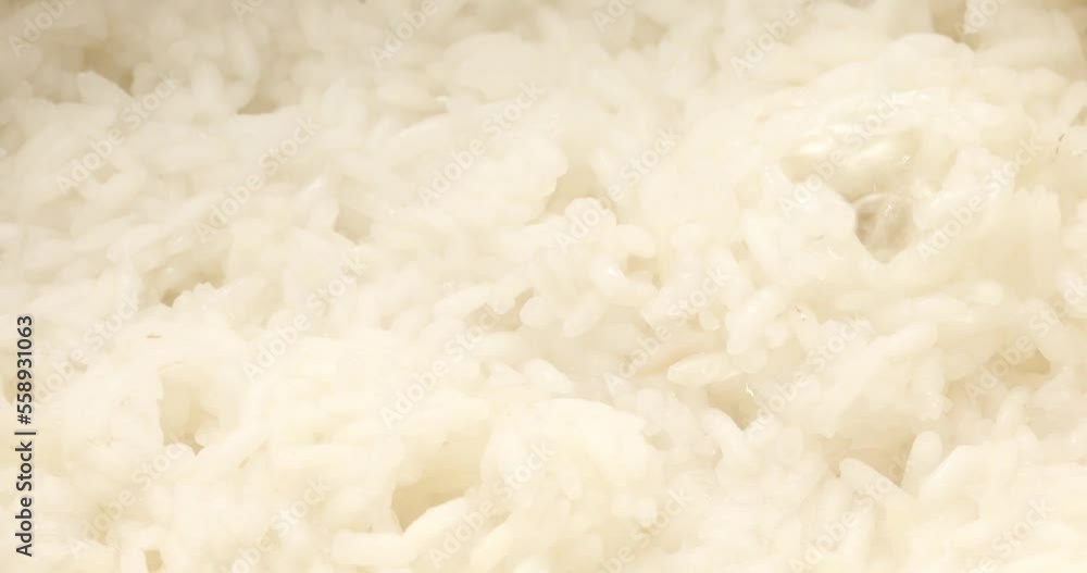 Rice cooking. Boiling water gurgles.Macro panoramic view Rice cooking. Boiling water gurgles.Macro panoramic view
