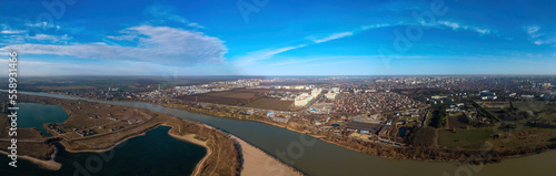 aerial landscape of the Kuban plain - a bend of the river, a lake and the outskirts of the city of Koasnodar on a sunny winter day