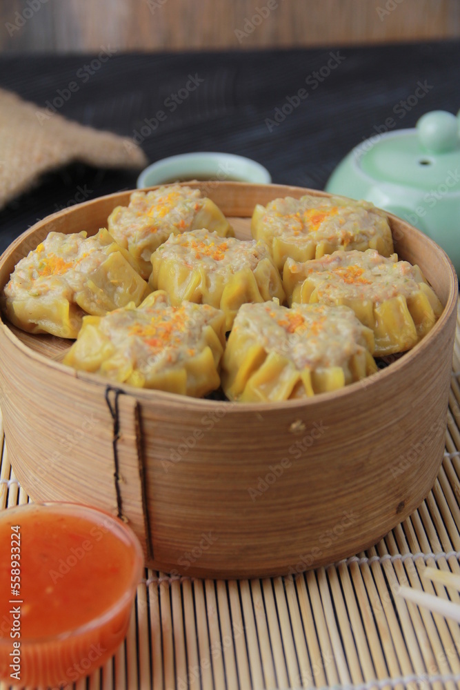 siomay dimsum filled with prawns, chicken, spring onions, on black background siomay dimsum filled with prawns, chicken, spring onions, on black background
