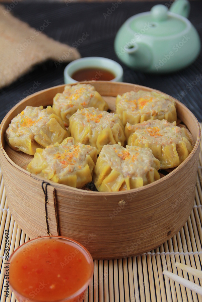 siomay dimsum filled with prawns, chicken, spring onions, on black background siomay dimsum filled with prawns, chicken, spring onions, on black background