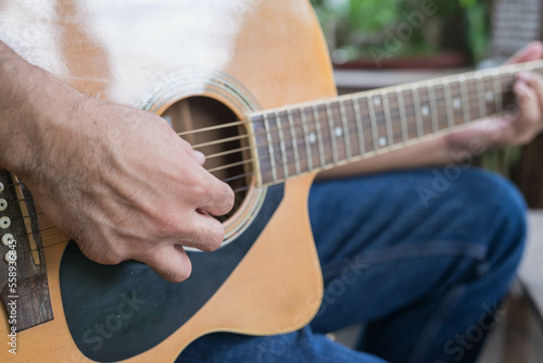 songwriter thinking and writing notes,lyrics in book at studio.man playing live acoustic guitar.concept for musician creative.artist composer in work process.people relaxing time with instrument
Photo