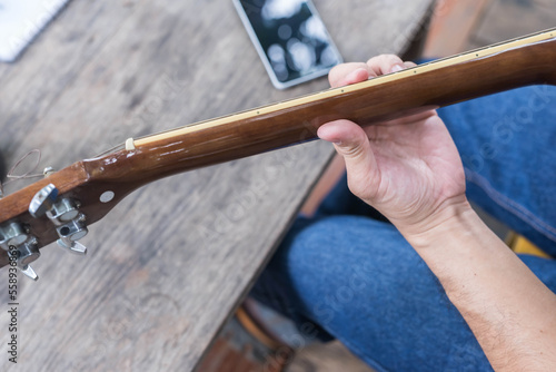songwriter thinking and writing notes,lyrics in book at studio.man playing live acoustic guitar.concept for musician creative.artist composer in work process.people relaxing time with instrument
Photo