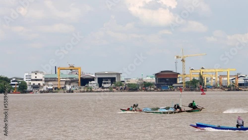 Thai fishermen in the Chao Phraya estuary returning with their catch of fish, Thailand photo