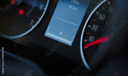 Fuel tank sign indicator on the dashboard display of a new car. Full gas tank during the rising prices.