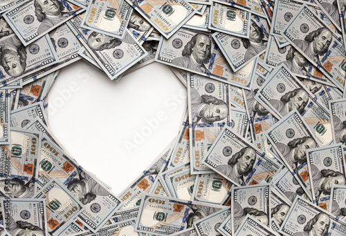 Dollar bills in the shape of heart. The love of money. Valentine's day concept. Heart shape sign with 100 dollar banknotes. Valentine concept background. cash gift for a loved one. holiday 14 February