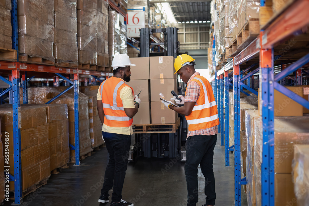 Worker in depot storage warehouse use tablet pc check scan barcode goods box and store on shelf Worker in depot storage warehouse use tablet pc check scan barcode goods box and store on shelf