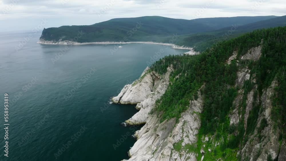 A bay near a mountain range. Aerial photography from a great height. Green trees grow on the mountains. A bay near a mountain range. Aerial photography from a great height. Green trees grow on the mountains.