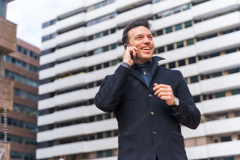 Middle-aged Caucasian businessman talking on the phone in the city, copy space Middle-aged Caucasian businessman talking on the phone in the city, copy space