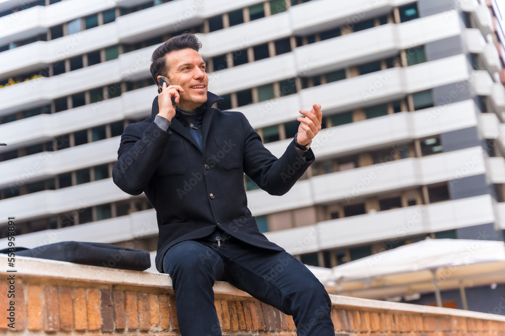 Middle-aged Caucasian businessman talking on the phone in the city, copy space Middle-aged Caucasian businessman talking on the phone in the city, copy space