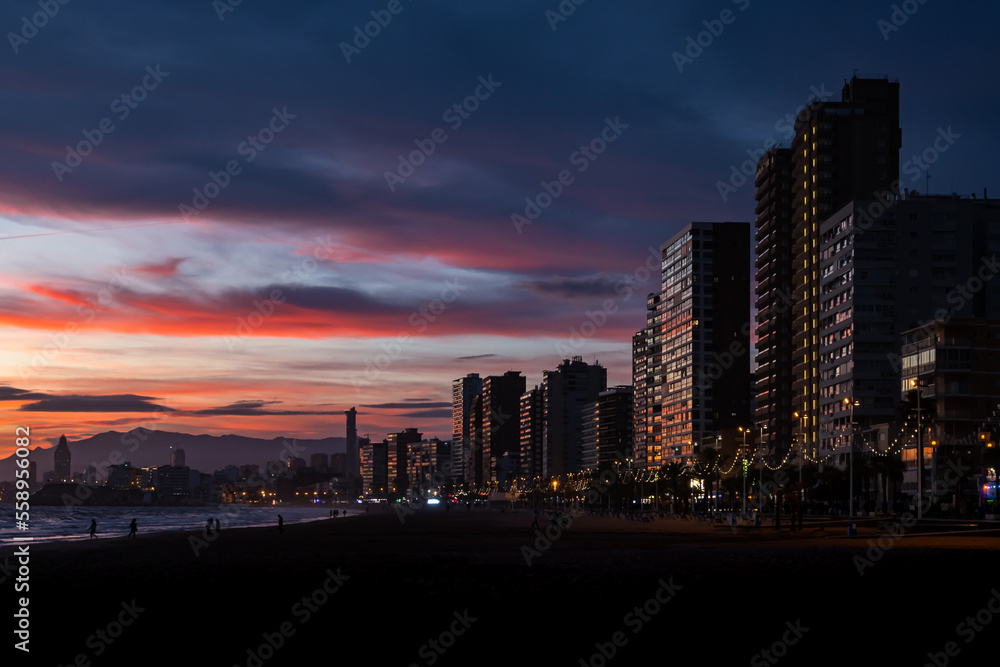 Fototapeta premium View of the skyline at sunset in winter from the promenade beach of Benidorm on the Costa Blanca, Alicante, Spain.