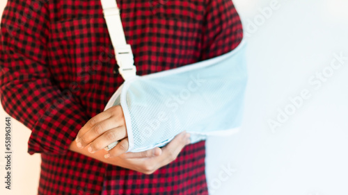 Boy in a splint, medical treatment, bone wrist rehabilitation due to falls, fractures, accidents, person. Soft focus and selective copy space for text