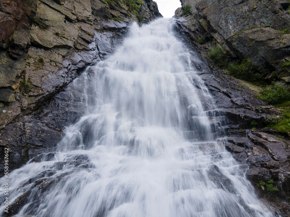 natural waterfall from the rocks in the mountain forest. long exposure