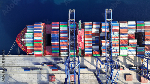 Print op canvas Aerial top down photo of industrial cargo container ship being loaded by large c