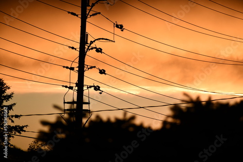 Electric pole in awsome fiery sunset in the city 