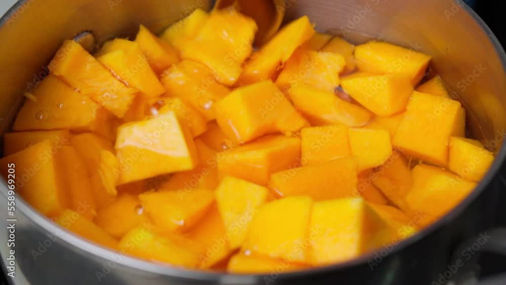 Cooking pumpkin in water, pumpkin soup. Selective focus. Diet soup in a pot. Cooking pumpkin in water, pumpkin soup. Selective focus. Diet soup in a pot.