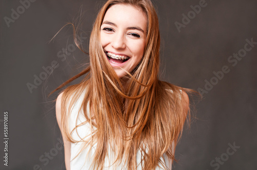 laughing girl wearing braces, cheerful portrait