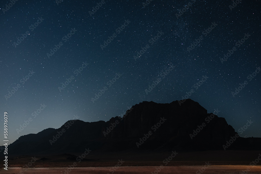 Nightsky over Wadi Rum mountains and desert landscape in Jordan