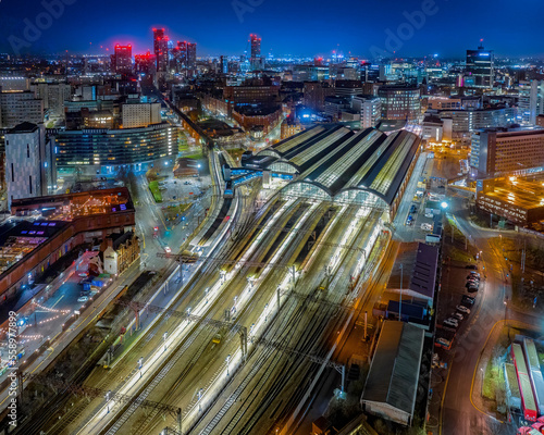 Fototapeta Picadilly train station Manchester City Centre and construction and redevelopment work at dawn with city lights and dark skies of this English city