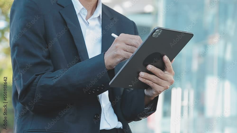 Businessman using tablet analyzing sales data and economic growth graph chart. Business strategy. Abstract icon. Digital marketing. Businessman using tablet analyzing sales data and economic growth graph chart. Business strategy. Abstract icon. Digital marketing.