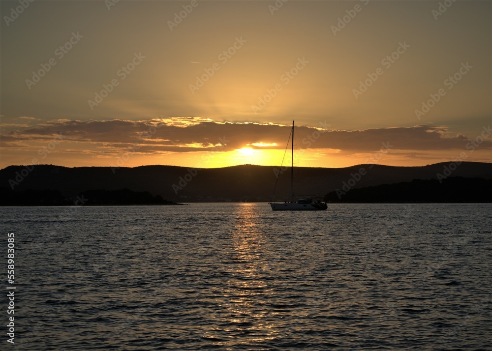Sailboat sailing in susnet on Adriatic coast near Biograd na Moru