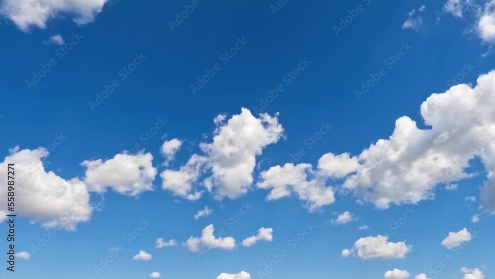 White clouds swirl in the blue sky.