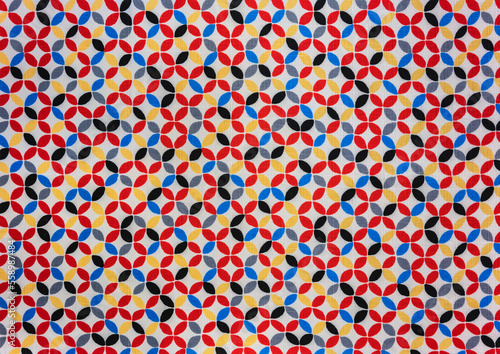 Close up on a fabric depicting a traditional japanese furoshiki fabric printed with a Shippotsunagi pattern depicting endlessly linked colorful circles which is an auspicious symbol of harmony.