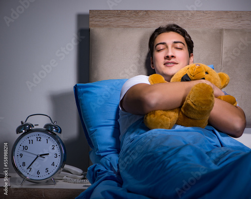 Young man sleeping in the bed photo