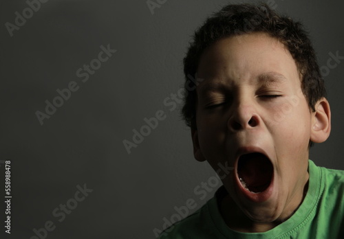 boy yawning with open mouth on black background with people stock image stock photo   photo