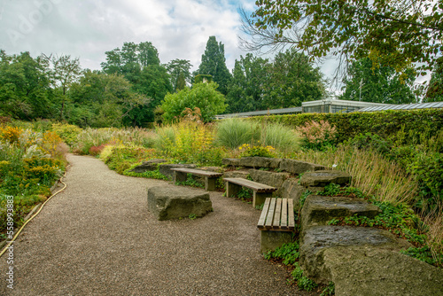 Картината върху платно Garden path and place fore rest (benches and stone-table for lunch)  in Botanica