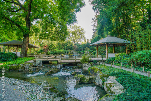 Wooden 2 gazebos and small waterfall in japanese gardenin Botanical garden in Augsburg