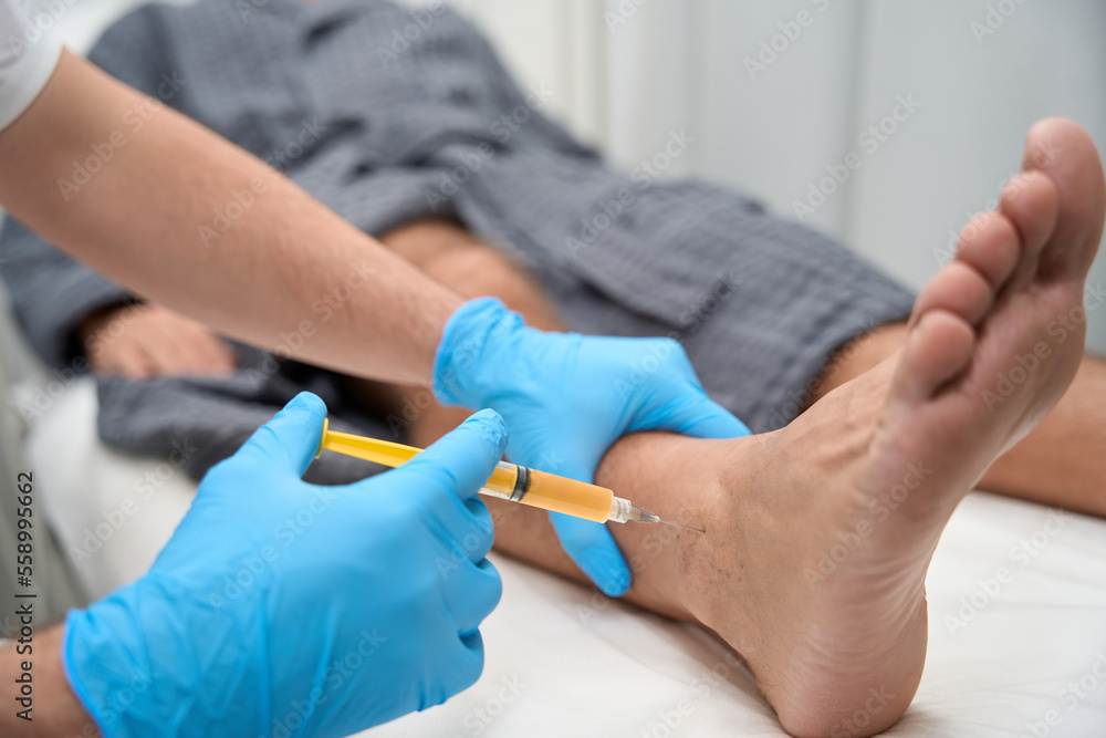 Medical specialist collecting a biopsy sample with a needle Medical specialist collecting a biopsy sample with a needle