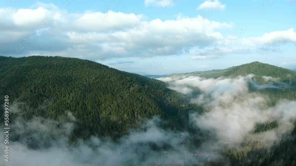 Aerial view of beautiful mountain landscape. Fog rises over the mountain slopes Aerial view of beautiful mountain landscape. Fog rises over the mountain slopes