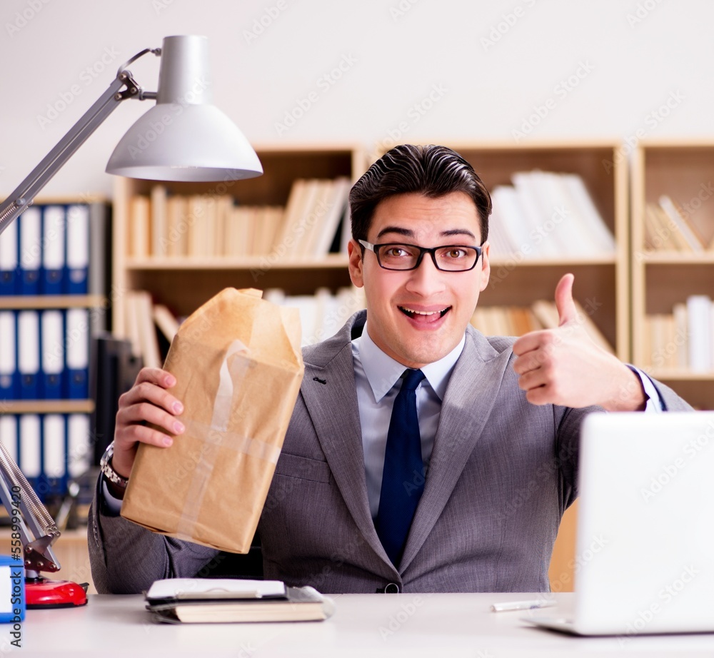Businessman receiving parcel in office Businessman receiving parcel in office