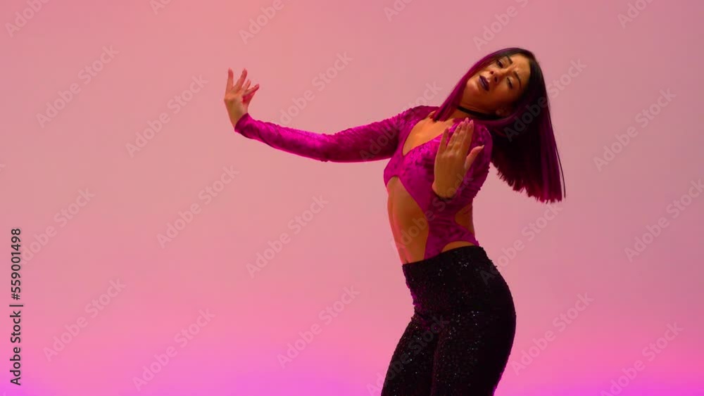 Women performing latin dance on a pink background Women performing latin dance on a pink background