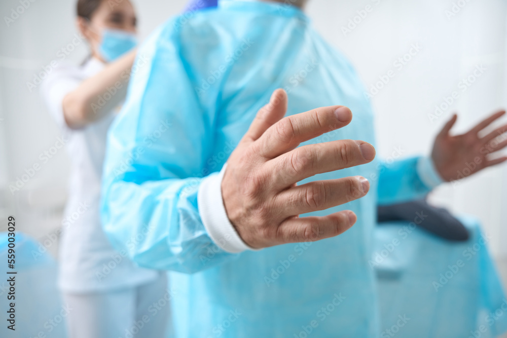 Cropped photo of surgeon is preparing for the operation Cropped photo of surgeon is preparing for the operation