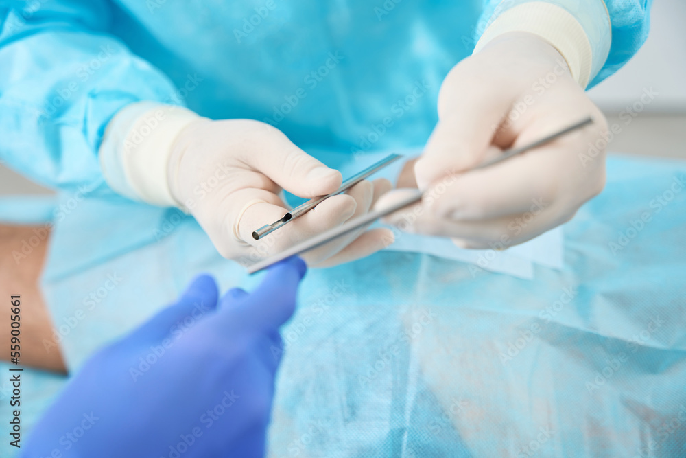 Doctor holds in his hands tools for installation of bioidentical hormones Doctor holds in his hands tools for installation of bioidentical hormones