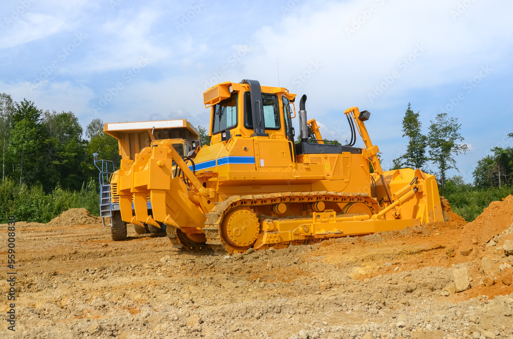 Crawler dozer working on construction site or quarry. Mining machinery moving clay, smoothing gravel surface for new road. Earthmoving, excavations, digging on soils Crawler dozer working on construction site or quarry. Mining machinery moving clay, smoothing gravel surface for new road. Earthmoving, excavations, digging on soils